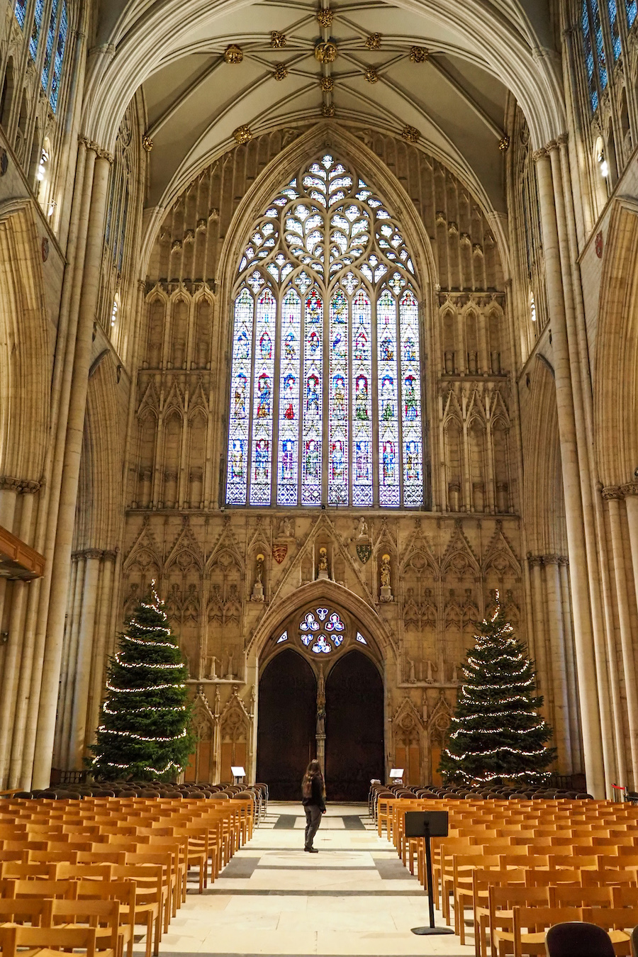 woman standing in the middle of an aisle inside York Minster