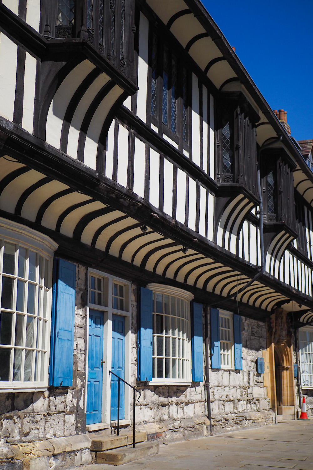 an old building in york with blue doors and shutters