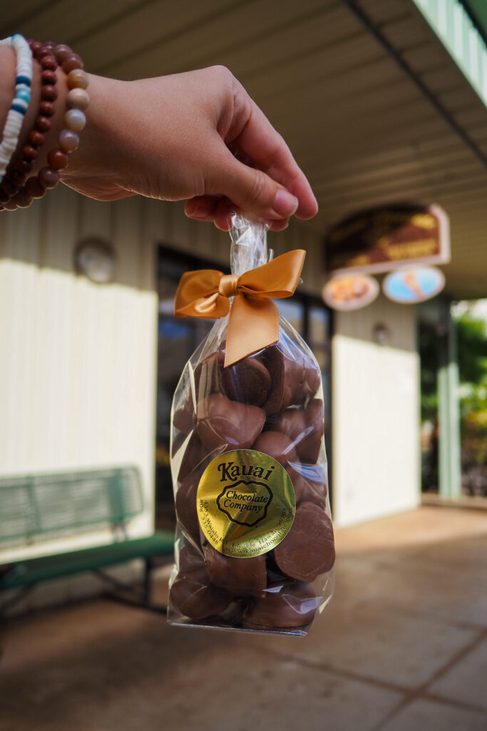 hand holding up a bag of chocolates from Kauai Chocolate Co