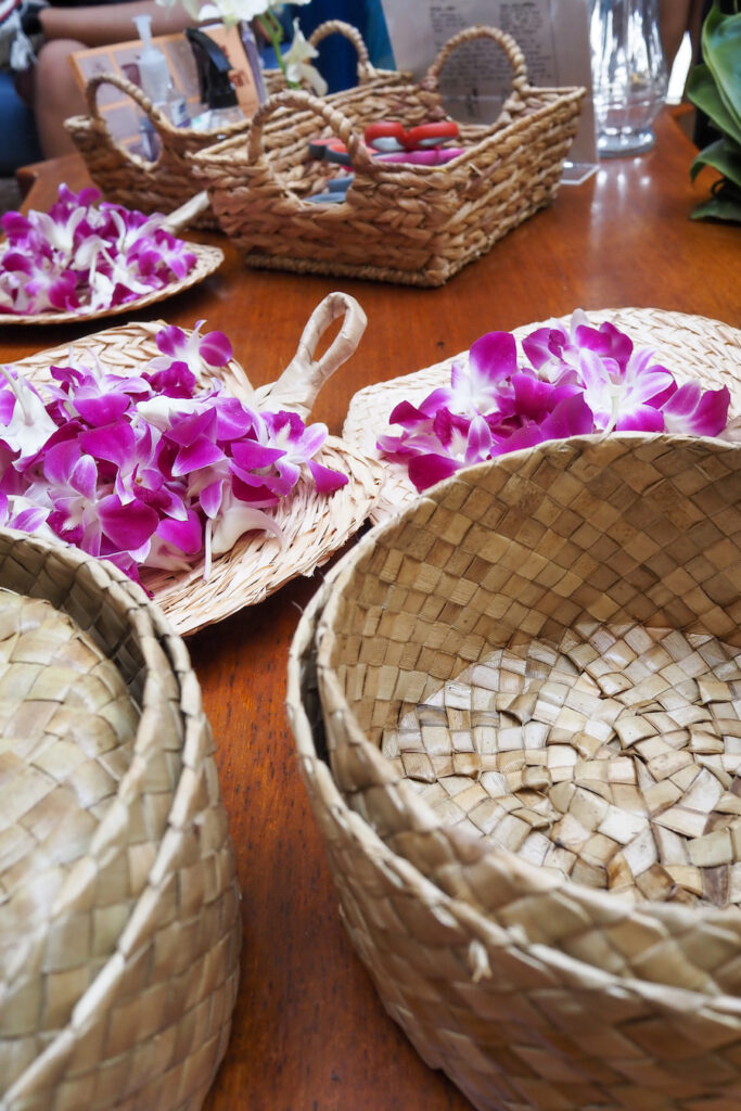 baskets with orchid flowers inside them on a table