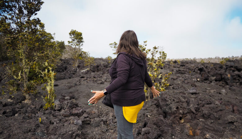 A woman in awe at all of the black cooled lava along the Chain of Craters Road