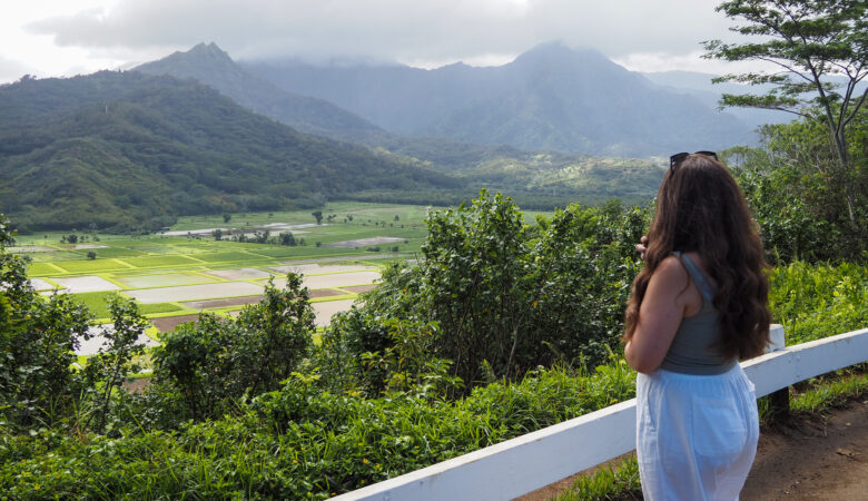 author, a young woman, looking out at the view at Hanalei Valley Lookout
