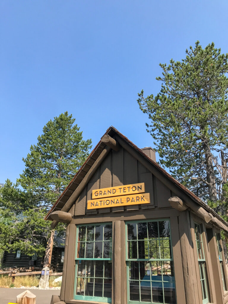 small cabin with sign that says "Grand Teton National Park"