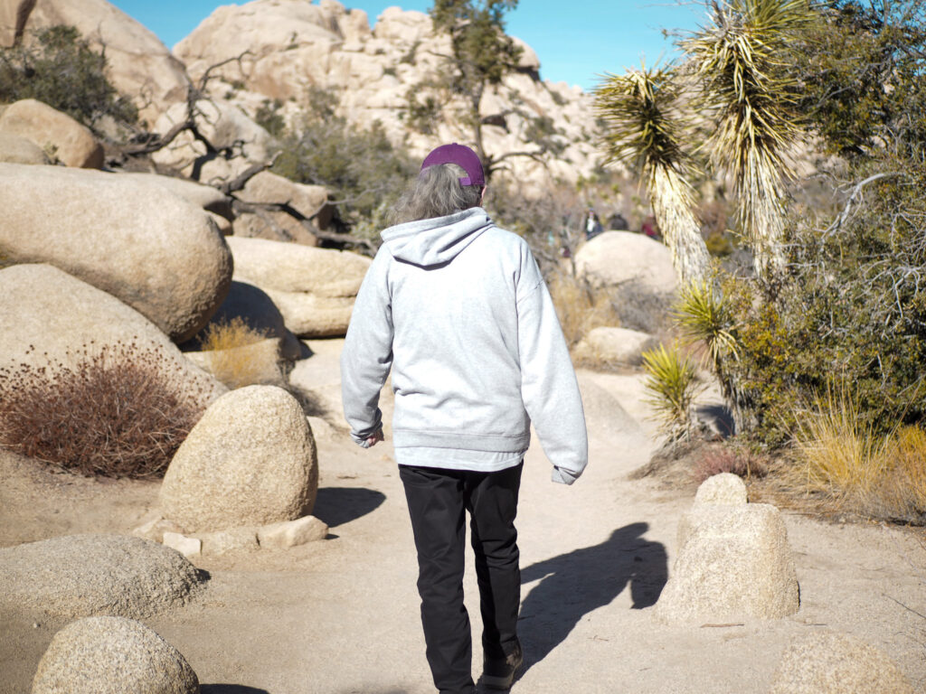 author's grandma walking on the Barker Dam Trail in Joshua Tree National Park