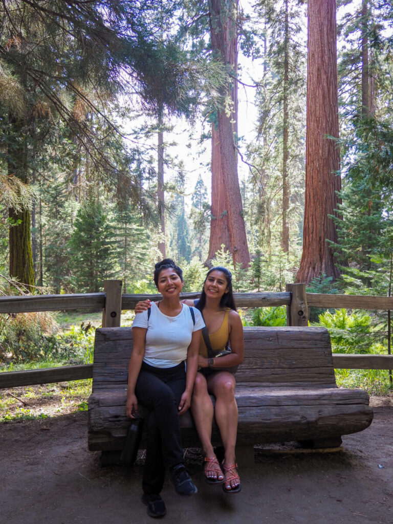 Friends sitting on a bench in Grant Grove in Kings Canyon National Park