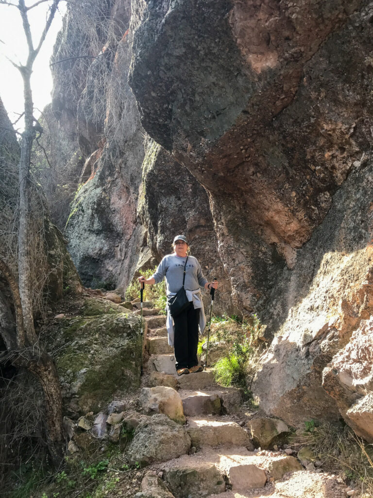Author's mom climbing some stone stairs on the trail to Bear Gulch Reservoir in Pinnacles National Park
