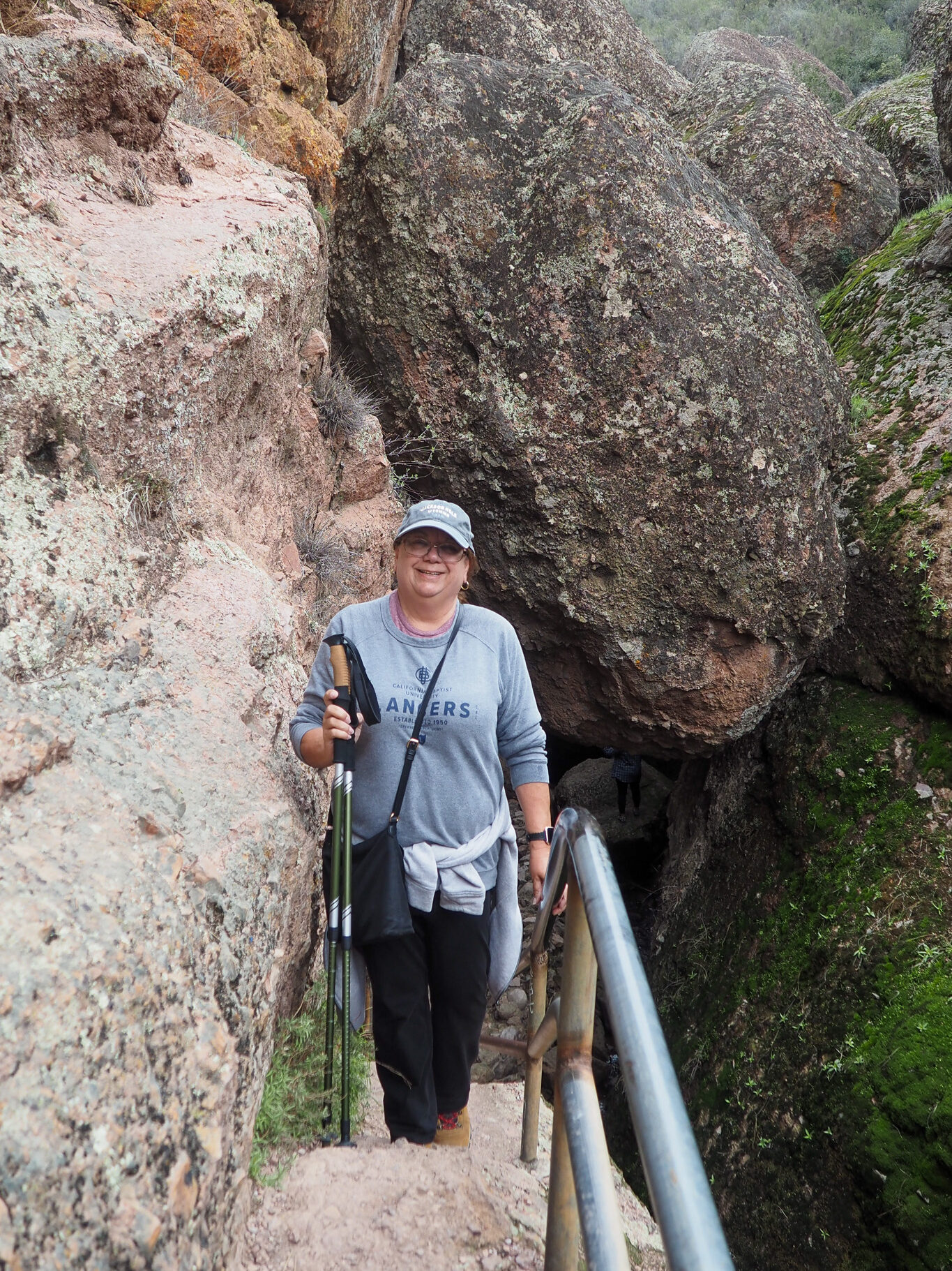 Author's mom climbing some stone stairs on the trail to Bear Gulch Reservoir in Pinnacles National Park