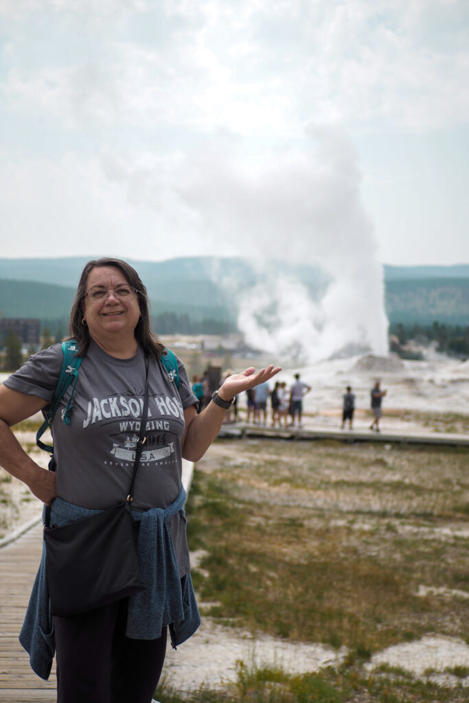Author's mom in front of Lion Geyser at Yellowstone National Park