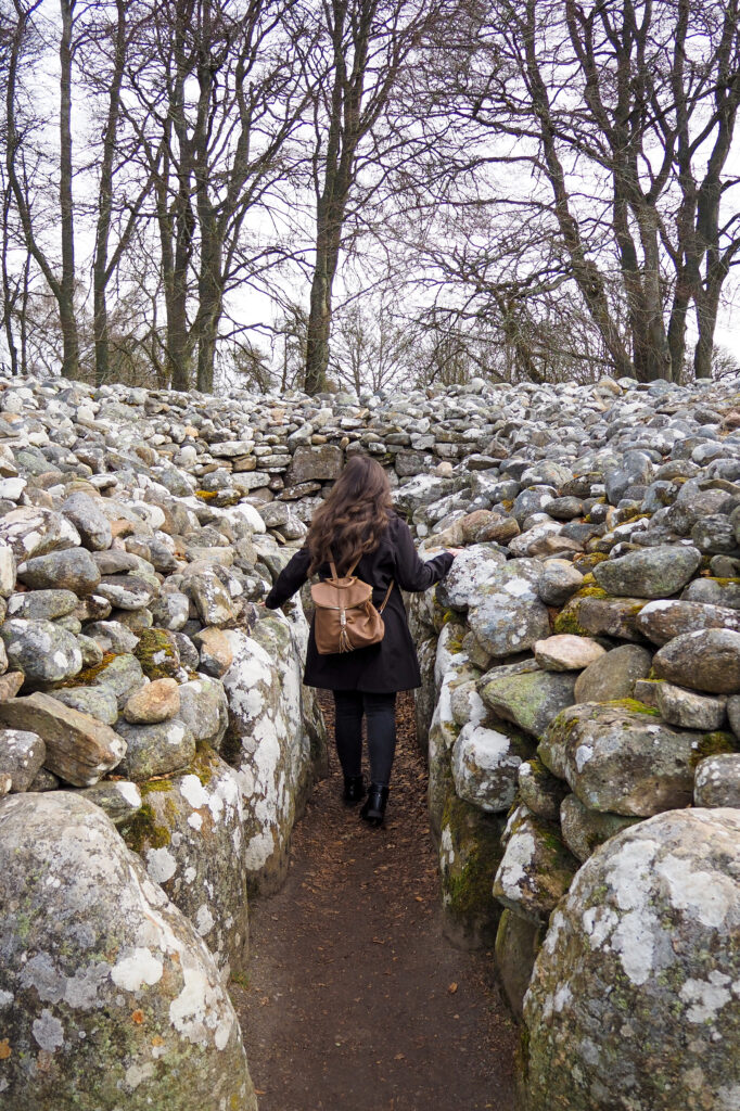 Author touching a stone at Clava Cairns near Inverness, Scotland