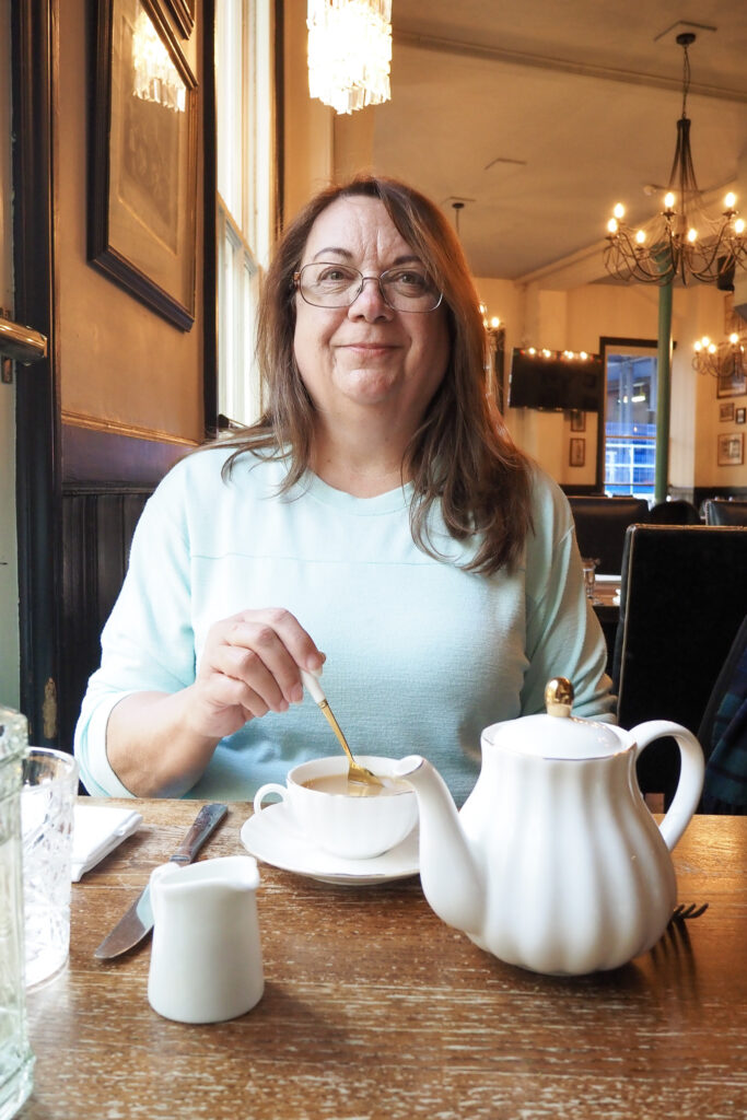 Author's mom at The Lamb Tavern in London, England during a long layover