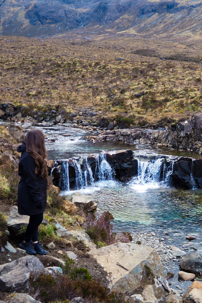 author, a young woman, near the fairy pools in isle of skye