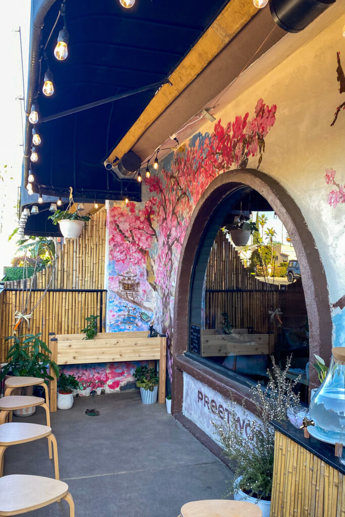 a cherry blossom tree painted onto a wall of the restaurant Hatsuzakura in San Diego