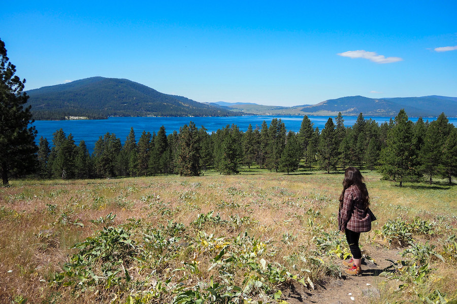 author on the trail in Wild Horse Island Montana looking out at the trees and water