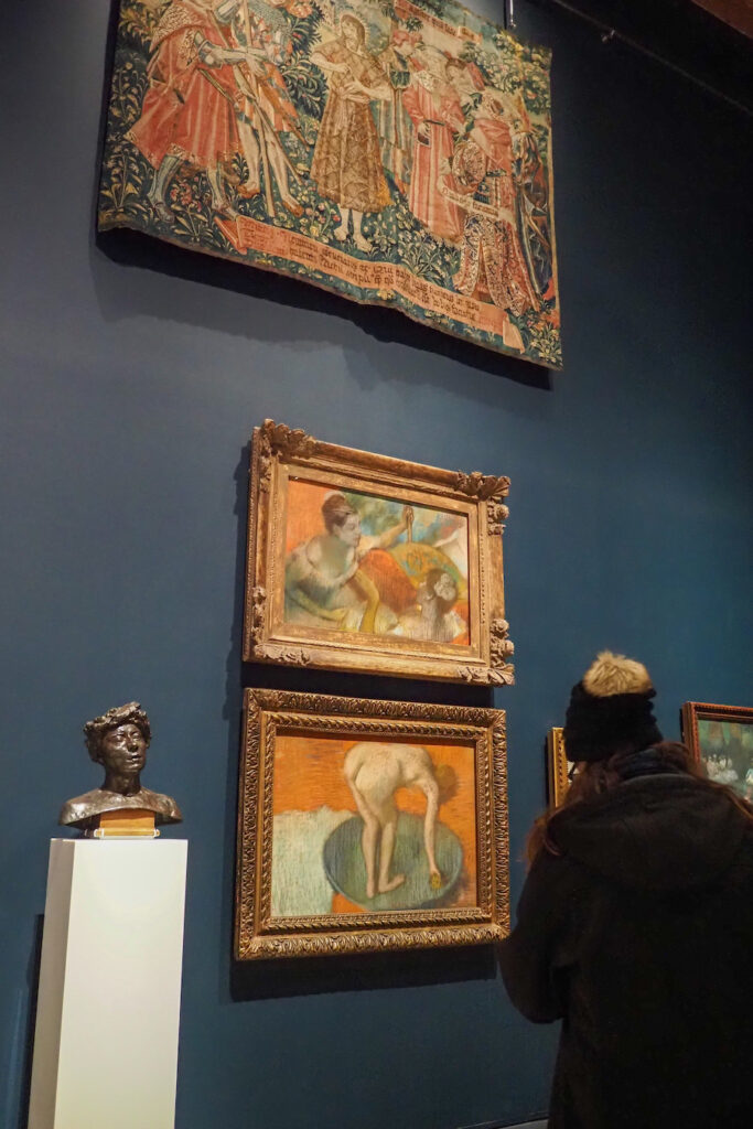 wall of famous paintings on display in the Burrell