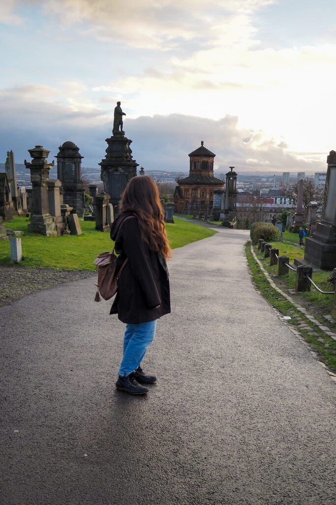 author, a young woman, standing on a sidewalk on the Glasgow Necropolis