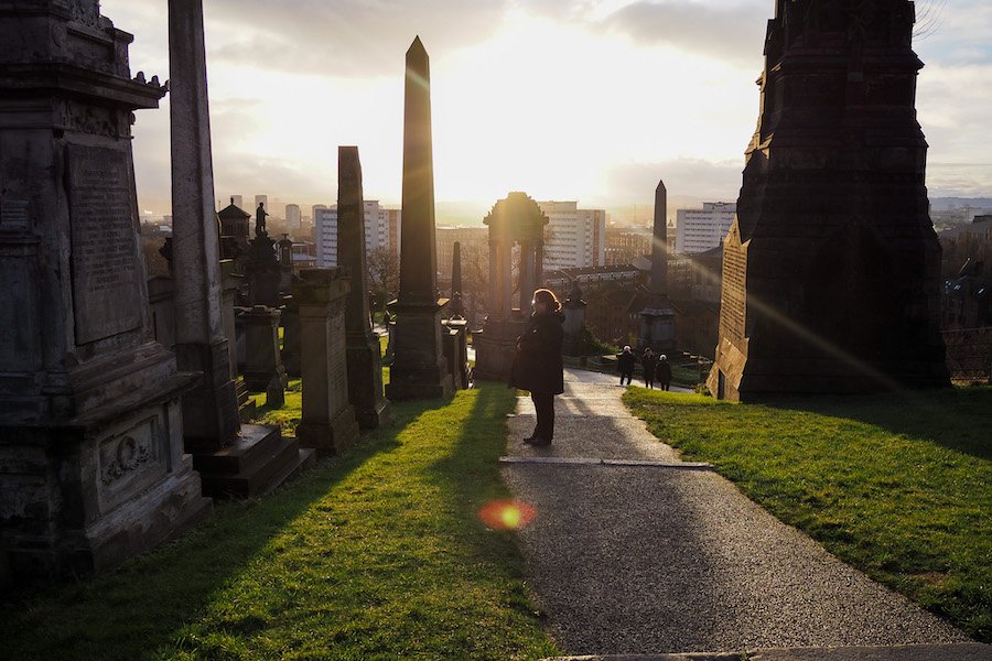 author's mom standing on a pathway in the Necropolis in Glasgow