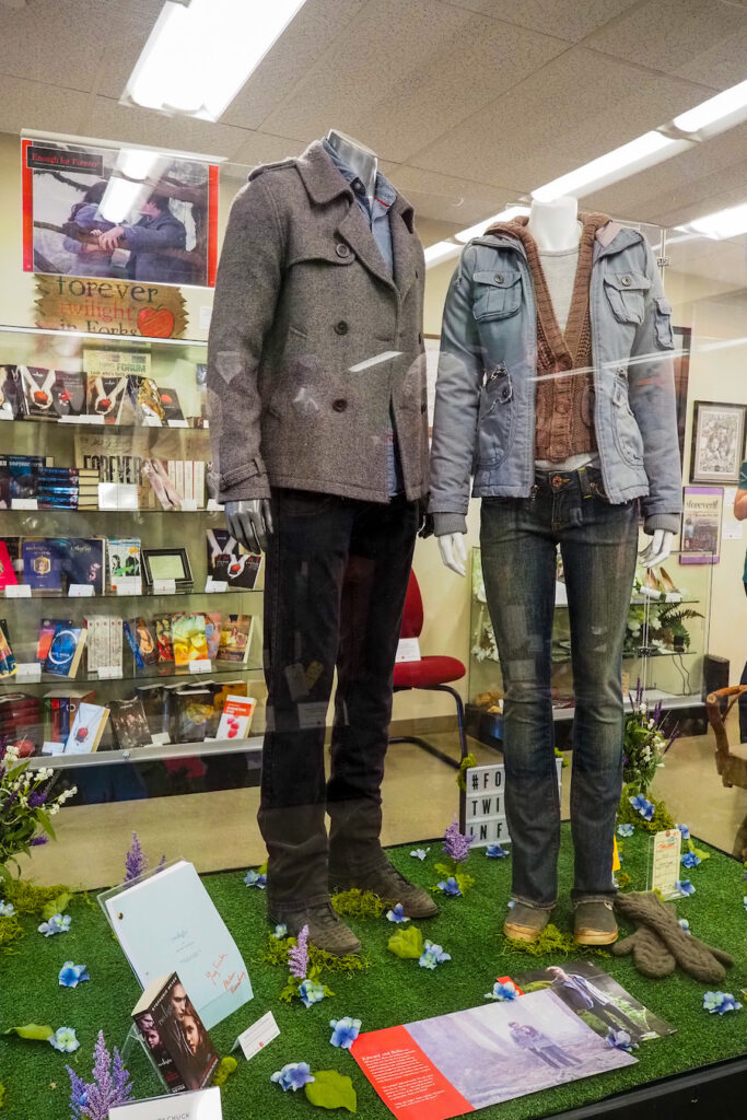 costumes on display in the twilight museum with special edition books beyond it