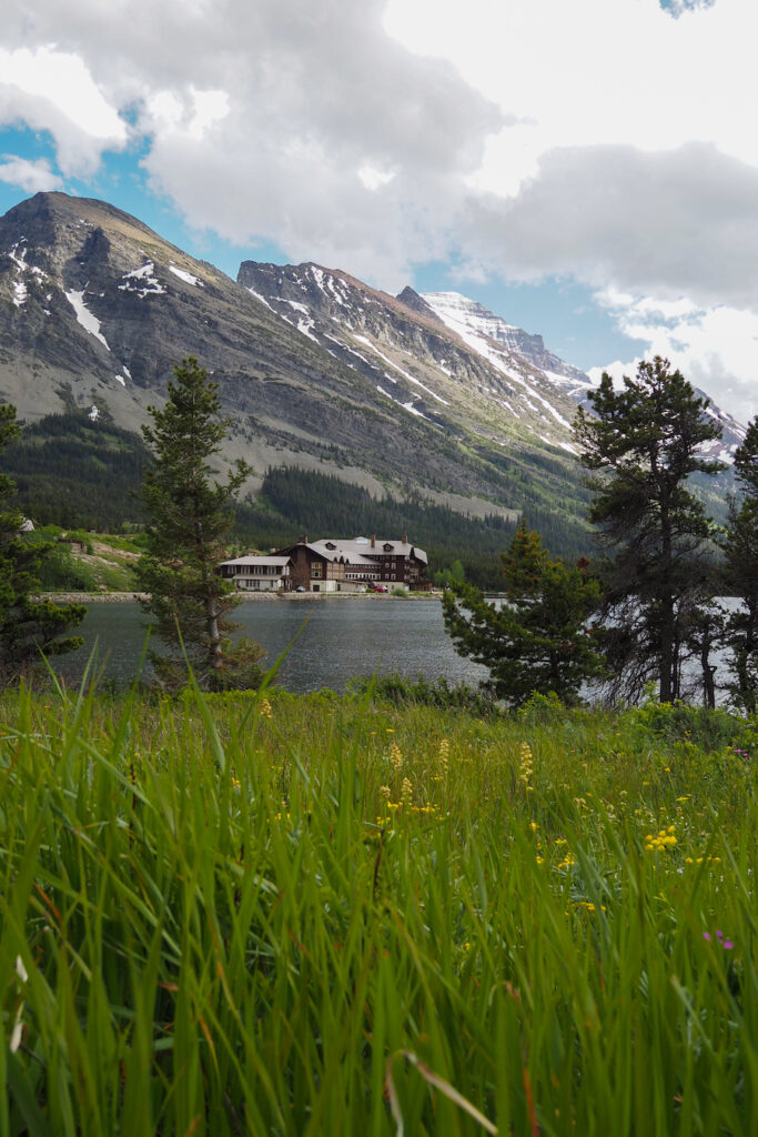 a view of the Many Glacier Hotel across from the lake in Glacier National Park