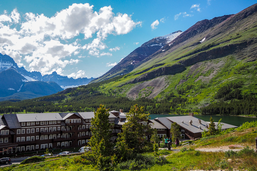 view of the Many Glacier Hotel on a sunny day from the parking lot
