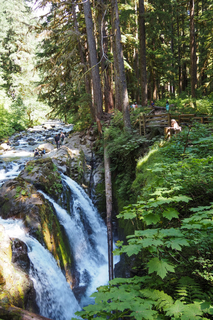 a three-streamed waterfall viewed from the top with greenery surrounding it