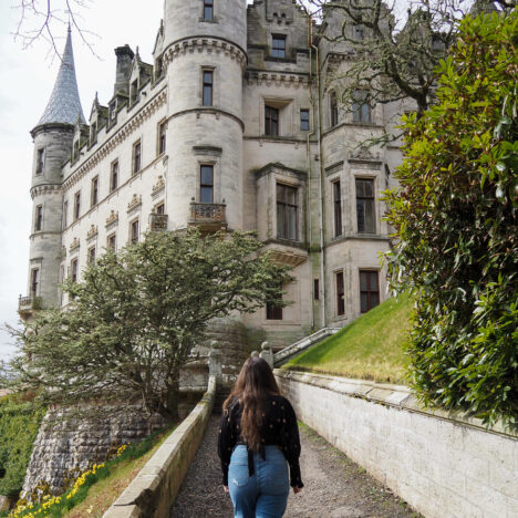 girl standing in front of Dunrobin Castle in Scotland